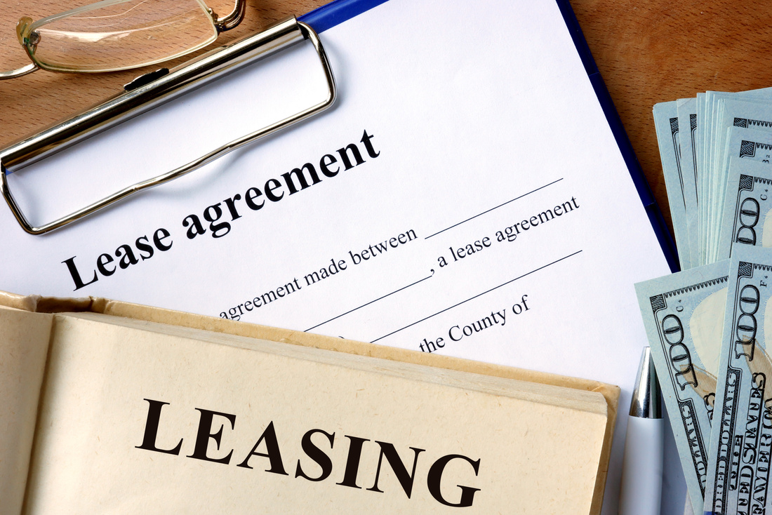 Book with word leasing,  lease agreement form.